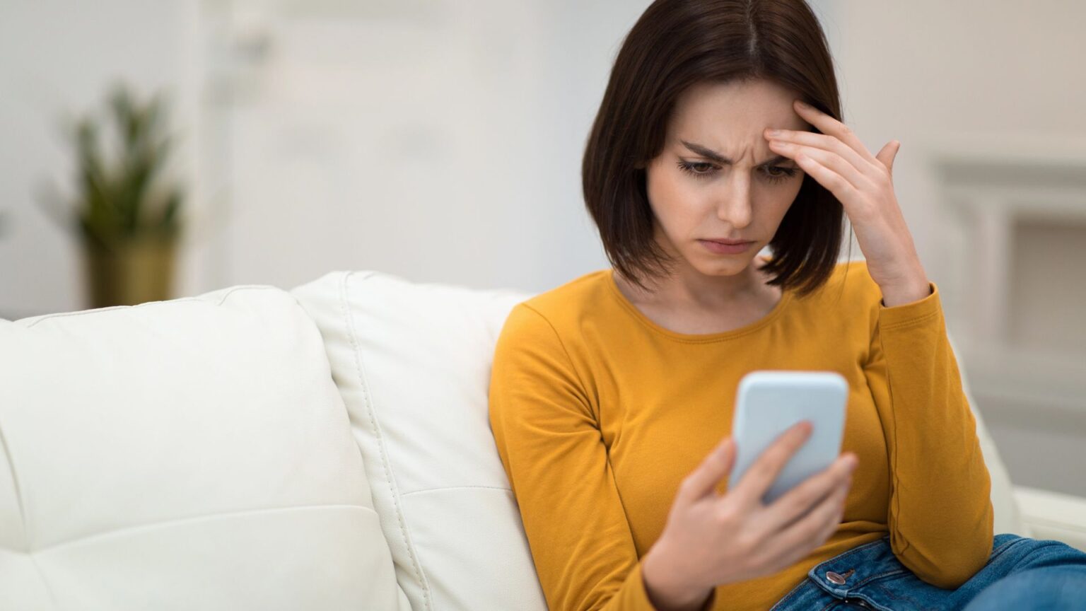 Donna guarda lo smartphone preoccupata